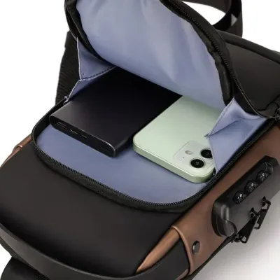 Front zipper compartment of Anti Theft Sling Bag open to show power bank and smartphone inside