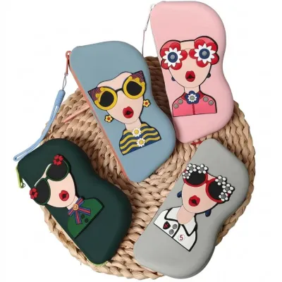 Four colorful Cartoon Sunglasses Case silicone pouches laid out in a fan shape on a woven coaster.