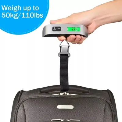 Hand holding a Digital Luggage Scale lifting a black travel bag, displaying 3.65 kg on the green screen.