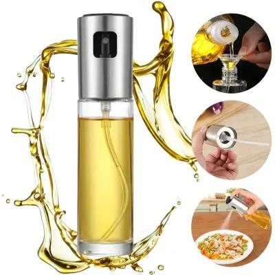 Clear glass oil spray bottle for kitchen with stainless steel pump top surrounded by oil splashes and usage steps.