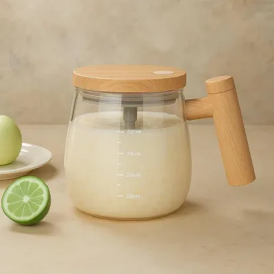 Self stirring glass mug with a wooden lid and handle filled with milk resting next to a sliced lime