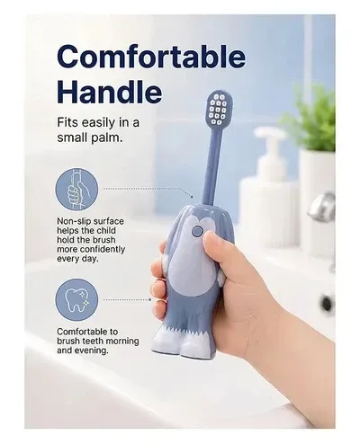 Child holding a grey Tom and Jerry Kids Toothbrush showing the non-slip ergonomic handle designed for small hands.